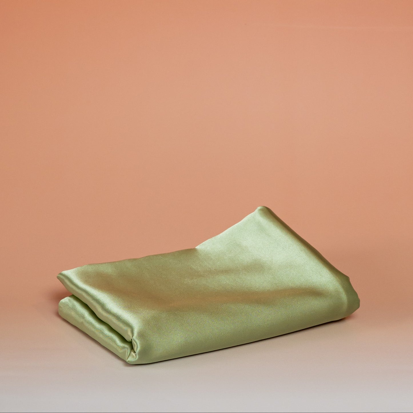 Green BLUSH satin pillowcase that helps reduce friction, protect hair and skin, and provide breathable comfort