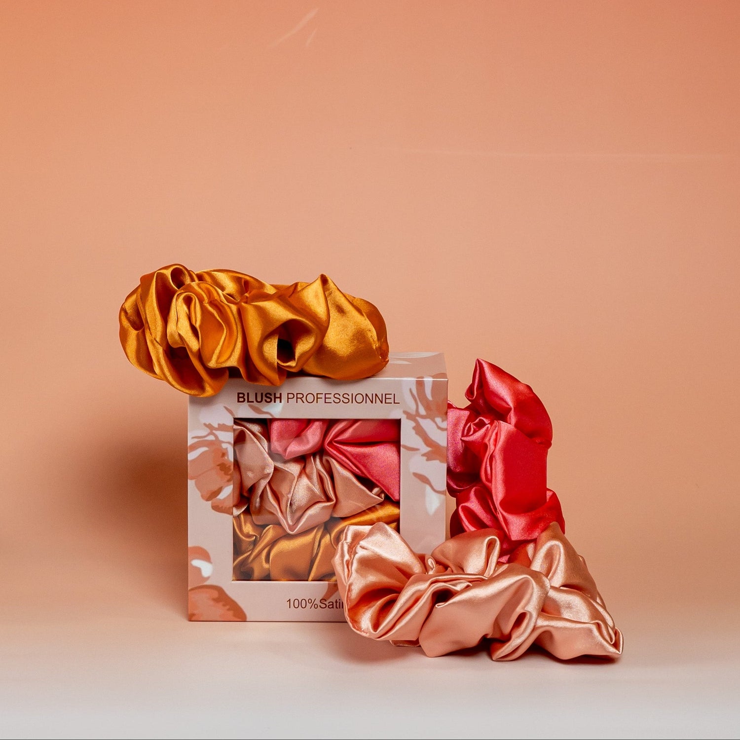 Orange BLUSH satin scrunchies gift box containing 3 satin scrunchies designed to protect hair and reduce breakage