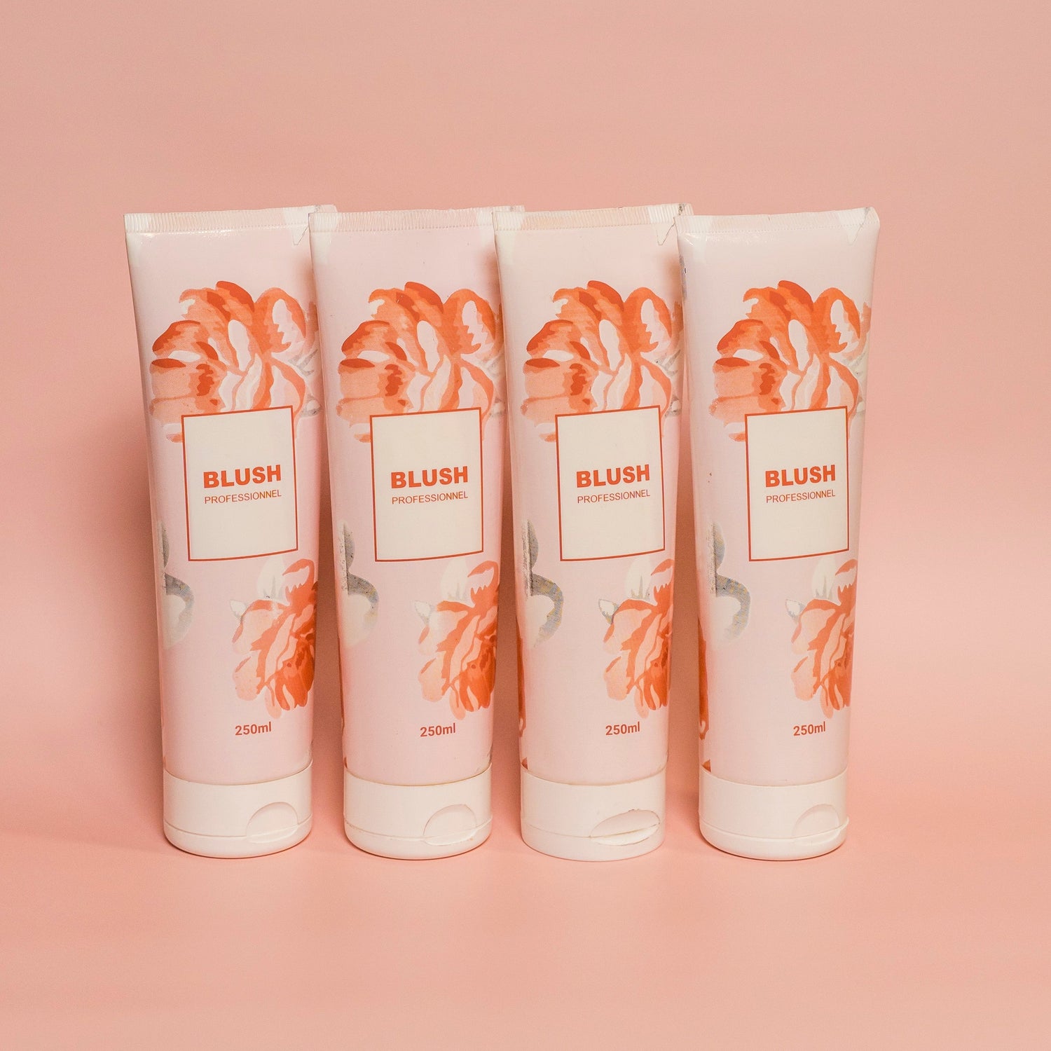 BLUSH signature hydrating hair mask collection of four products arranged in an artistic layout symbolizing nourishment and soft, healthy hair