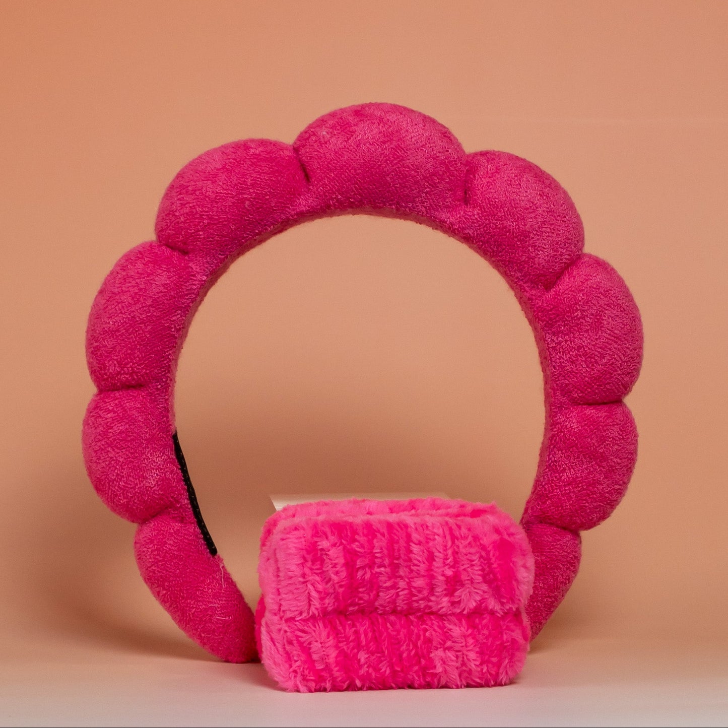 Dark pink BLUSH skincare headband and wristband set designed to keep hair dry and away from the face during skincare routines