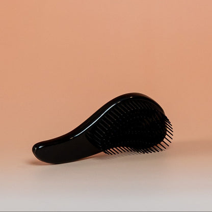 Black BLUSH detangling brush for effortless detangling on dry, damp, or wet hair