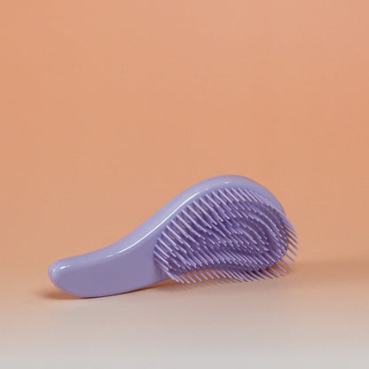 Purple BLUSH detangling brush that gently detangles dry, damp, or wet hair