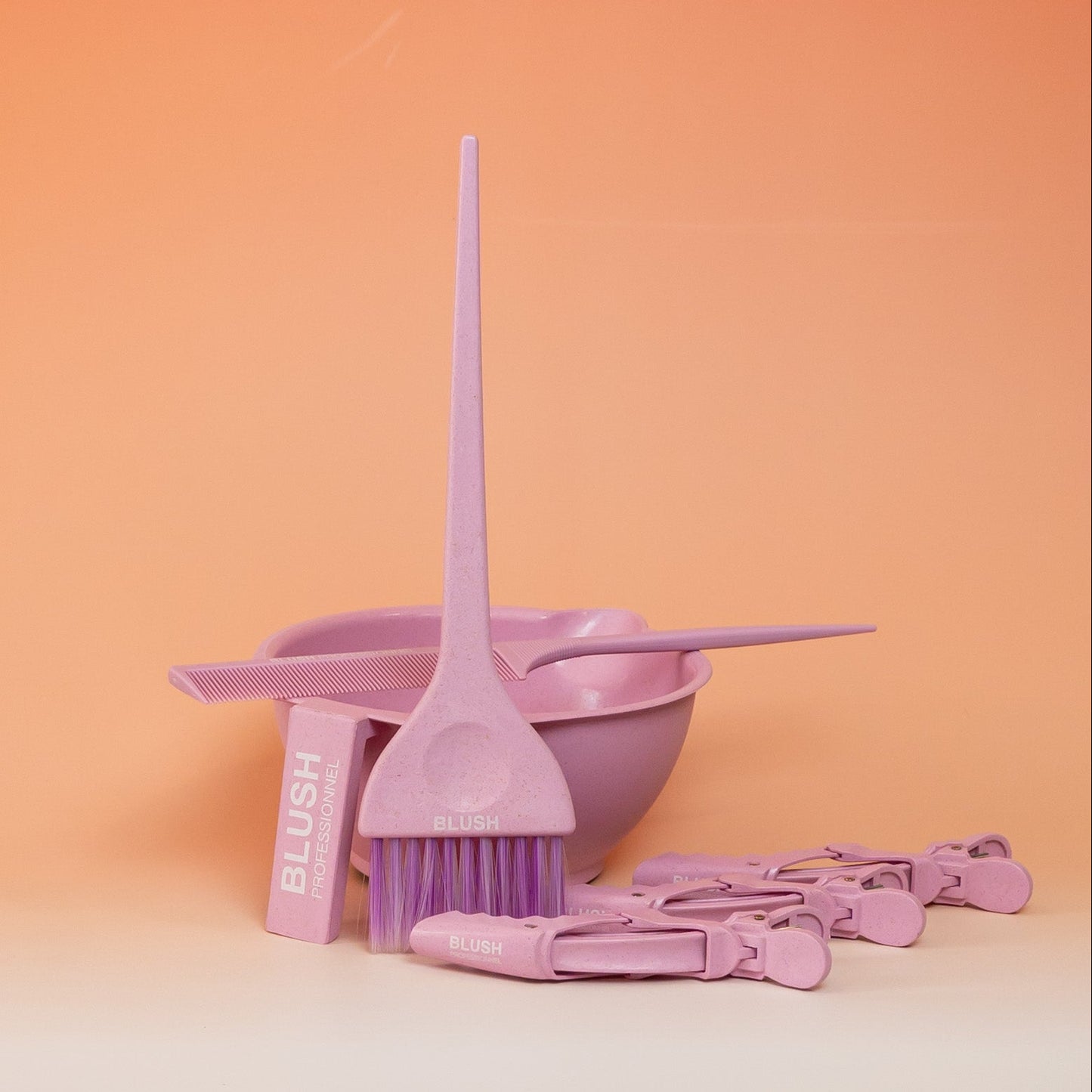 Pink BLUSH hair application kit including a mixing bowl, application brush, tail comb, and three sectioning clips for easy and precise product application