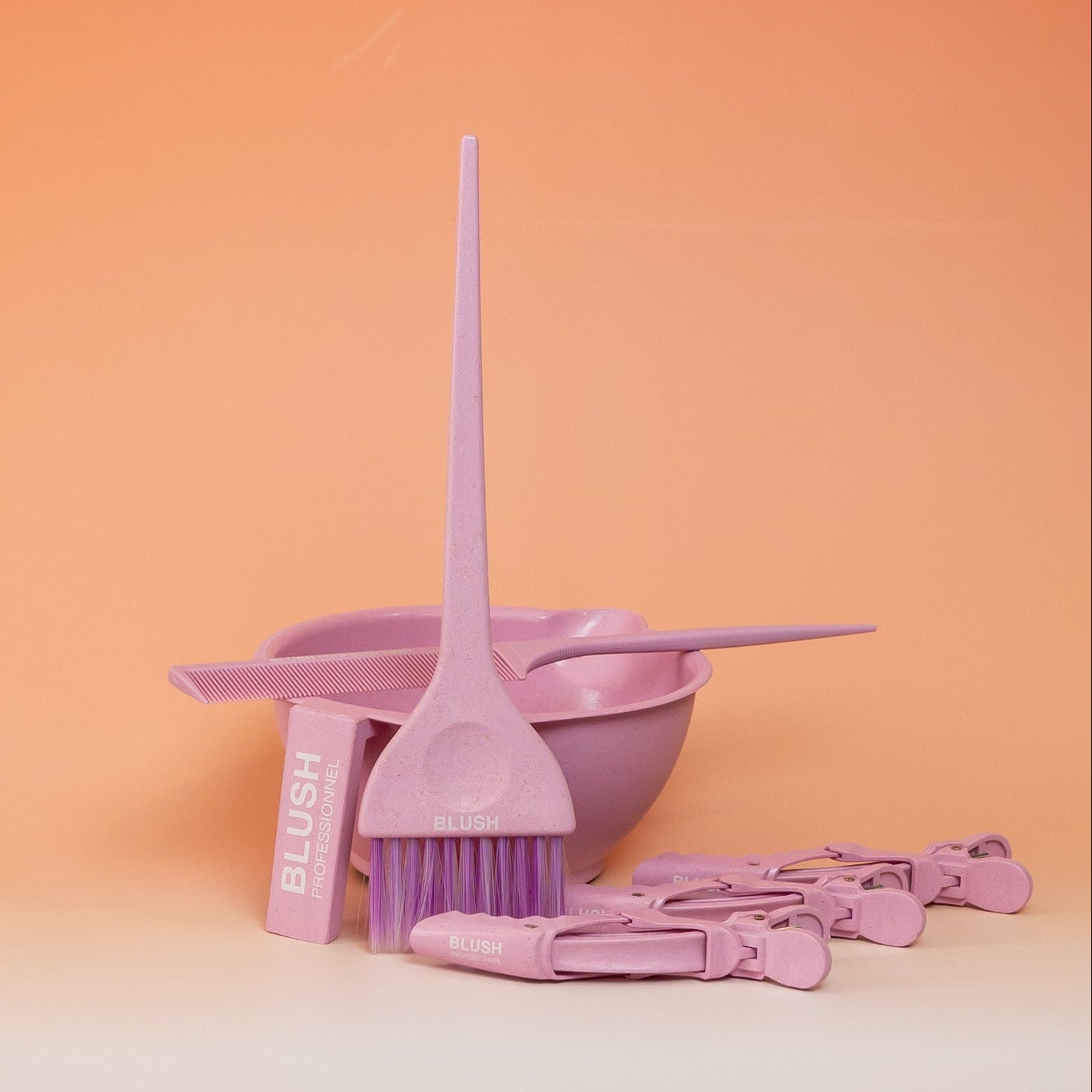 Pink BLUSH hair application kit including a mixing bowl, application brush, tail comb, and three sectioning clips for easy and precise product application