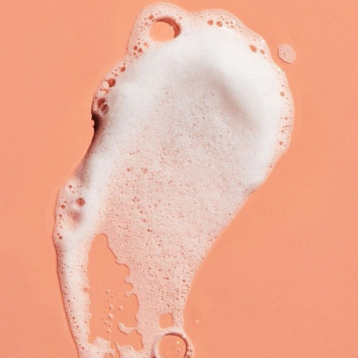 Close-up of BLUSH hydrating shampoo showing its light, airy foam texture designed to gently cleanse hair while hydrating the scalp
