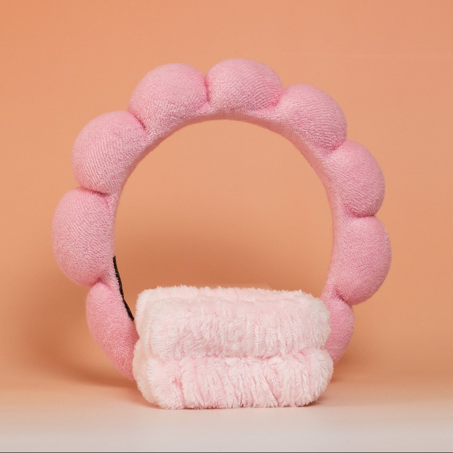Light pink BLUSH skincare headband and wristband set designed to keep hair in place and prevent it from getting wet during skincare routines