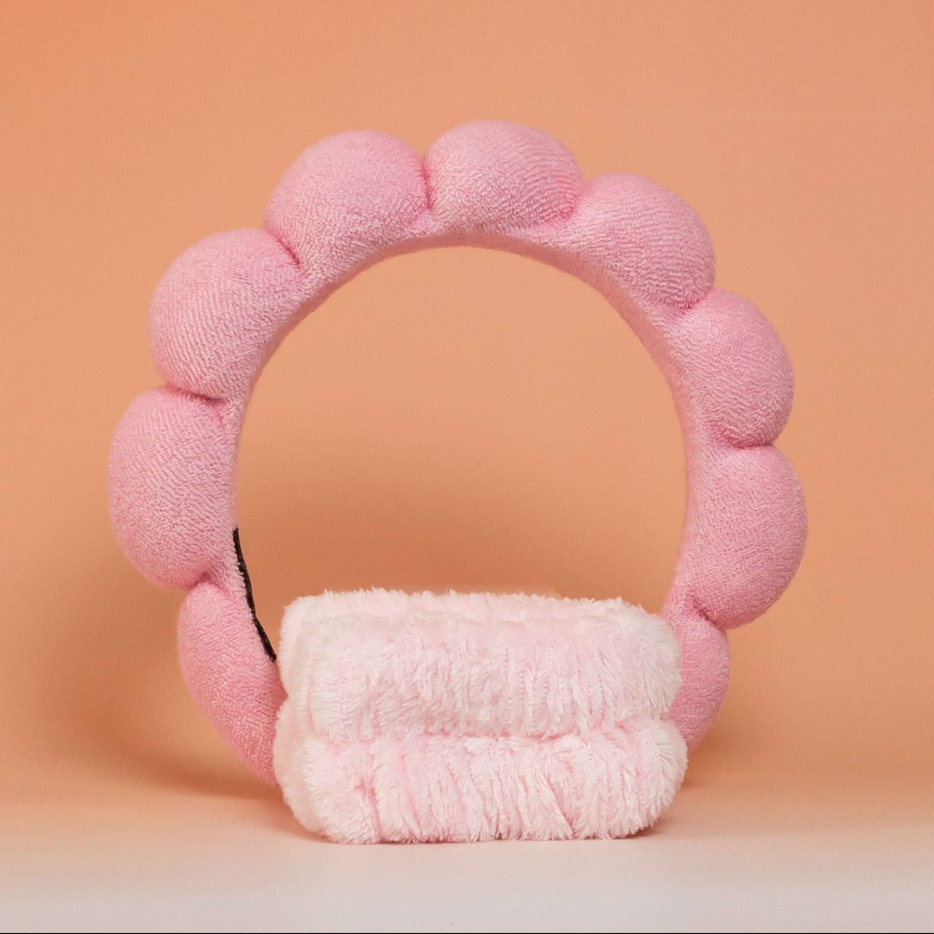 Light pink BLUSH skincare headband and wristband set designed to keep hair in place and prevent it from getting wet during skincare routines