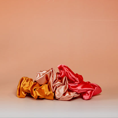 Set of 3 orange BLUSH satin scrunchies designed to protect hair and reduce breakage