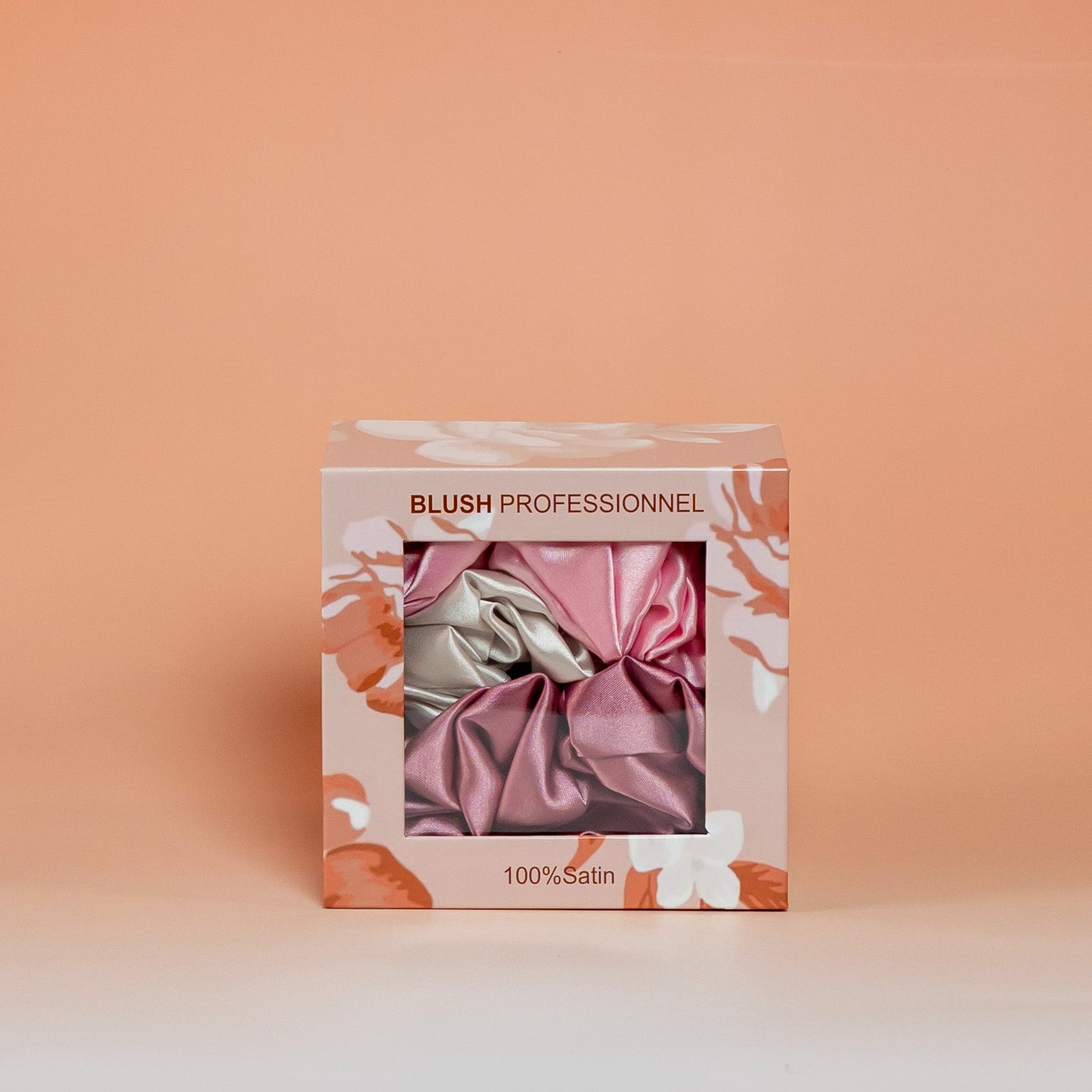 Pink BLUSH box containing a set of 3 satin scrunchies designed to help reduce hair breakage and friction