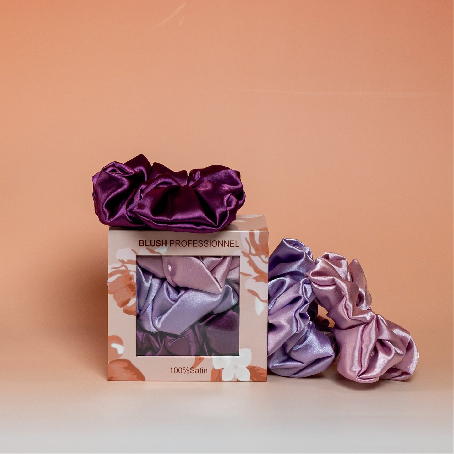 Purple BLUSH satin scrunchies gift box containing 3 satin scrunchies that gently hold hair while reducing friction and breakage