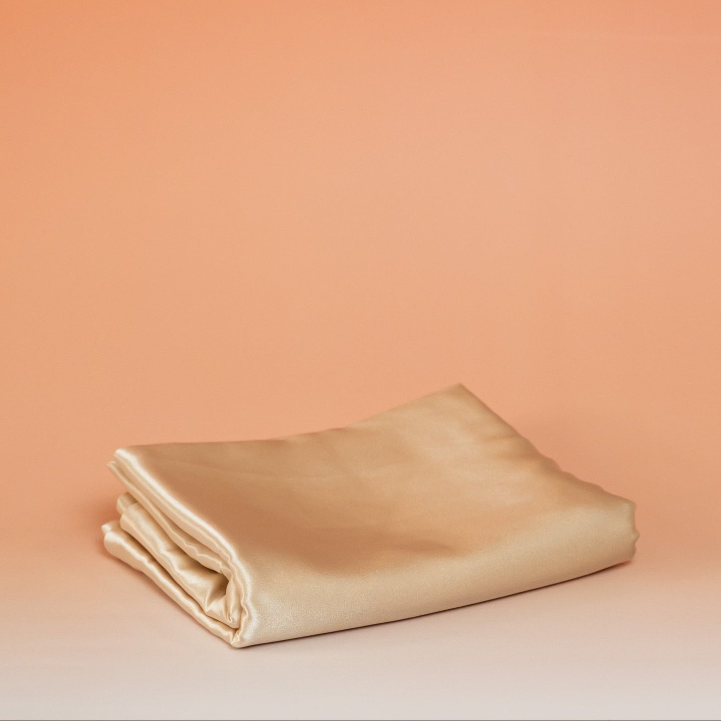 Beige BLUSH satin pillowcase that helps reduce friction, protect hair and skin, and provide breathable comfort