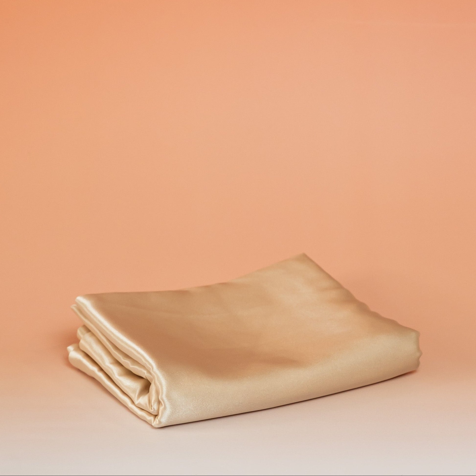 Beige BLUSH satin pillowcase that helps reduce friction, protect hair and skin, and provide breathable comfort