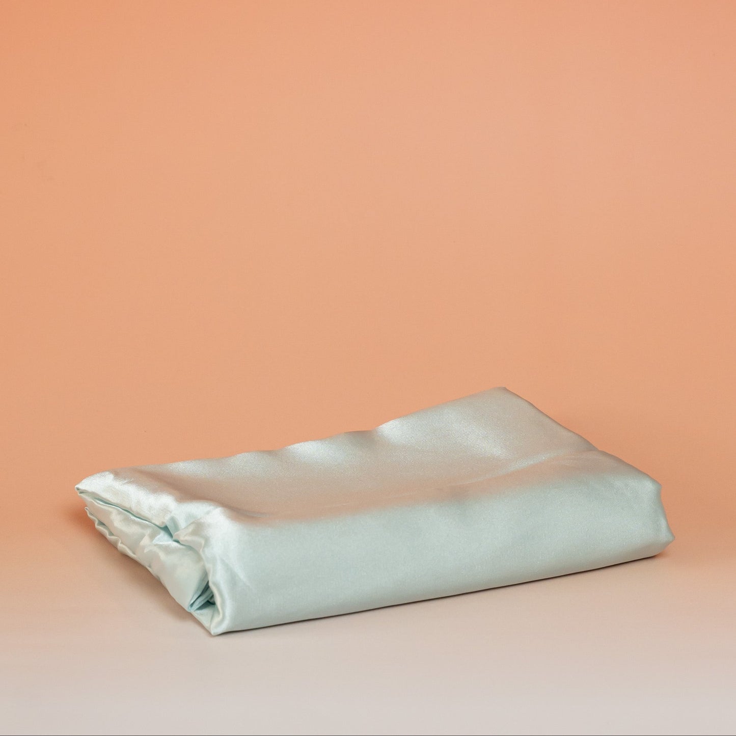 Blue BLUSH satin pillowcase that helps reduce friction, protect hair and skin, and provide breathable comfort