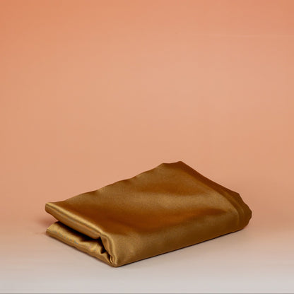 Caramel BLUSH satin pillowcase that helps reduce friction, protect hair and skin, and provide breathable comfort