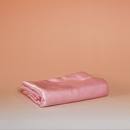 Dark pink BLUSH satin pillowcase that helps reduce friction, protect hair and skin, and provide breathable comfort.