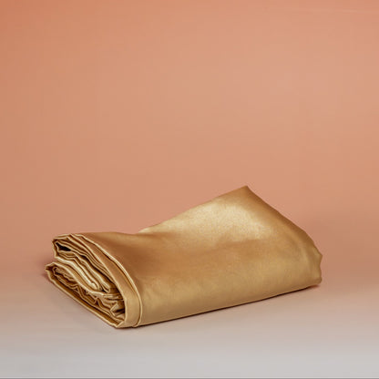 Gold BLUSH satin pillowcase that helps reduce friction, protect hair and skin, and provide breathable comfort