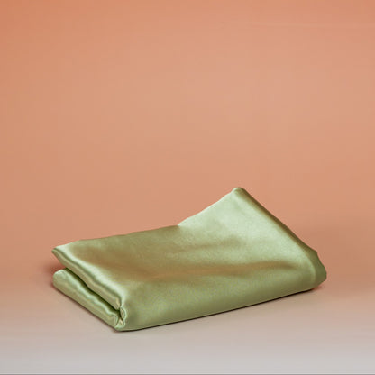 Green BLUSH satin pillowcase that helps reduce friction, protect hair and skin, and provide breathable comfort