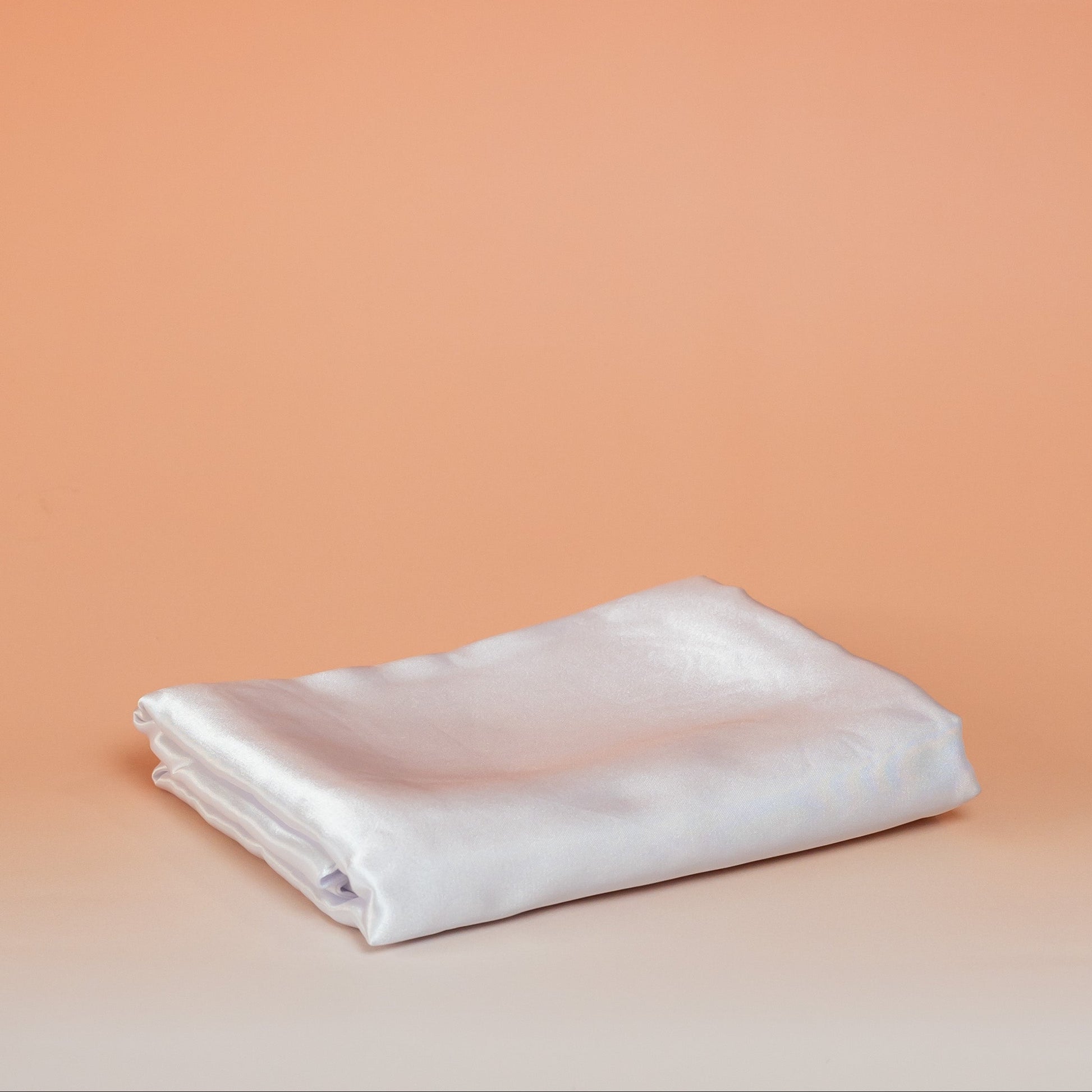 White BLUSH satin pillowcase that helps reduce friction, protect hair and skin, and provide breathable comfort