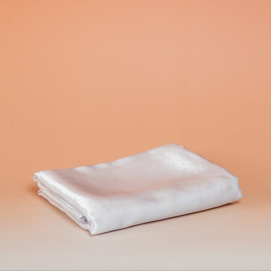 White BLUSH satin pillowcase that helps reduce friction, protect hair and skin, and provide breathable comfort
