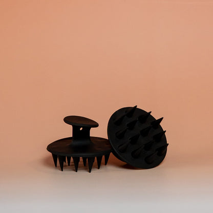 Black BLUSH silicone scalp scrubber brush that gently massages the scalp, promotes blood circulation, and supports healthy hair growth