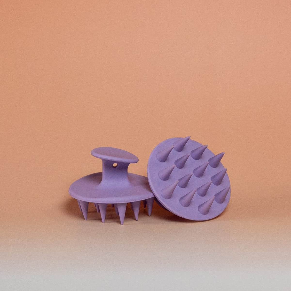 Purple BLUSH silicone scalp scrubber brush that gently massages the scalp, promotes blood circulation, and supports healthy hair growth