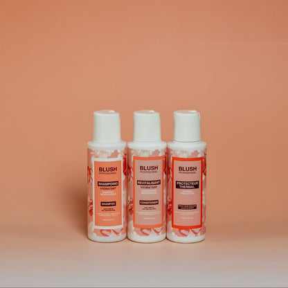 BLUSH travel-size hair care trio including shampoo, conditioner, and heat protectant (100 ml each), designed to hydrate, soften, and add shine to hair